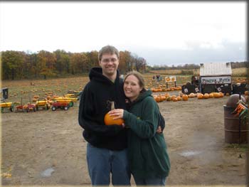 picture of Ted and Lara with pumpkin with a diamond ring on top of it